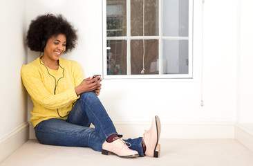 young woman checking her phone and listening to music.