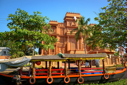 Traditional Indian boat with historic building at background in
