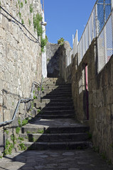 Fototapeta na wymiar Staircase and a narrow street