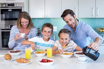 Obraz na płótnie Canvas Happy family having breakfast together