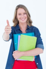 Smiling student holding notebook and file