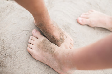 Toddler feet on sand at the beach
