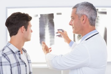 Naklejka na ściany i meble Doctor explaining X rays to his patient