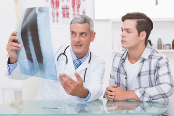 Doctor showing X rays to his patient