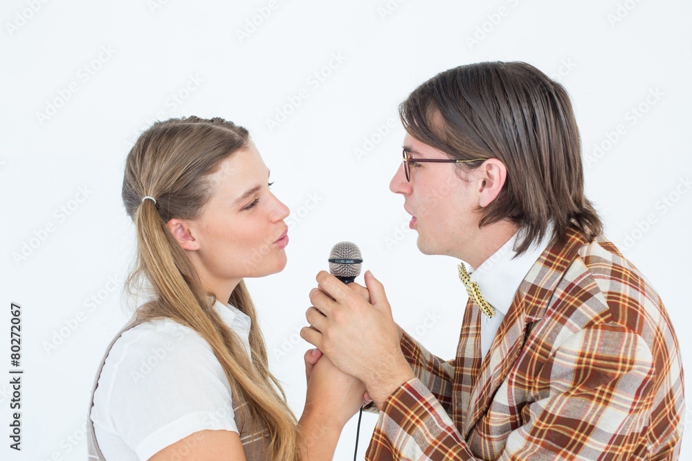 Poster happy geeky hipsters singing with microphone