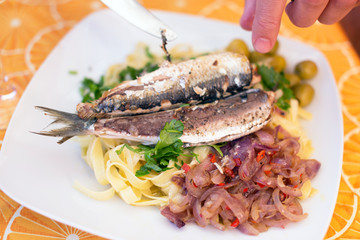 Fish and pasta on white plate