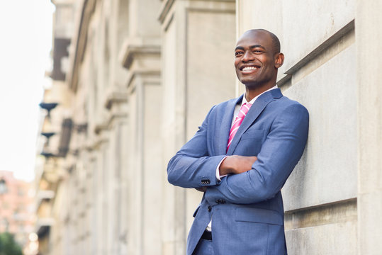 Handsome black man wearing suit in urban background