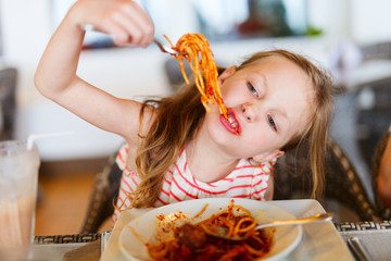 Little girl eating spaghetti
