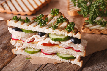 Sandwich with chicken and vegetables on the table. horizontal