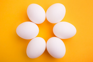 White eggs on a yellow background
