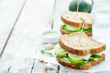 sandwiches with avocado, cheese, cabbage and cheese and herb top