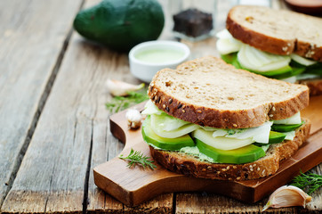 sandwiches with avocado, cheese, cabbage and cheese and herb top