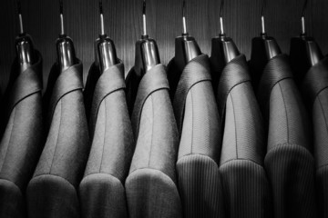 Row of men suit jackets. Black and white image.