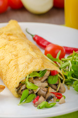Omelette stuffed with mushrooms and microgreens