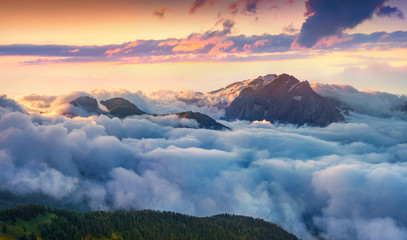 Panorama of the sunrise in foggy Val di Fassa valley