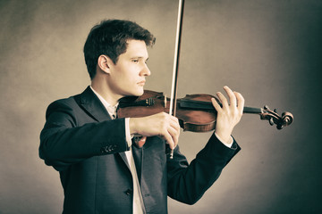 Man violinist playing violin. Classical music art