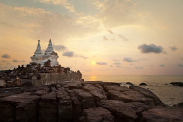 Beautiful sunset over the island with small temple silhouette