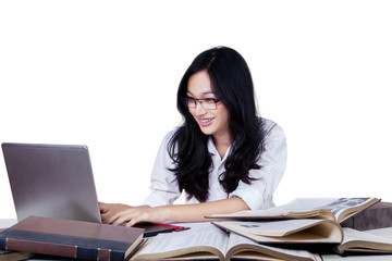 Student with long hair studying at desk