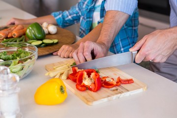 Happy family preparing vegetables together