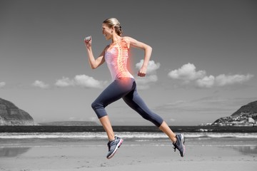 Fototapeta na wymiar Highlighted back bones of jogging woman on beach