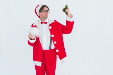 Fototapeta na wymiar Geeky hipster in santa costume looking at mistletoe