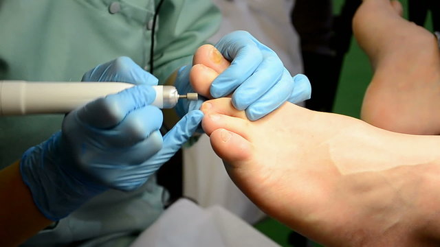 nails polishing closeup (pedicure) in beauty salon