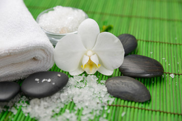 Obraz na płótnie Canvas Spa setting with orchid ,stones ,towel ,many salt
