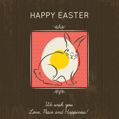 Easter card with egg and rabbit on wooden background.