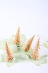 Obraz na płótnie Canvas green tea ice cream cones dropped upside down
