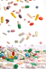 colorful medicine pills falling.