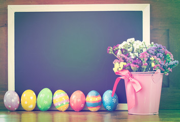 Colorful easter eggs and flower with backboard in vintage soft c