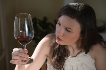 Young woman drinking red wine