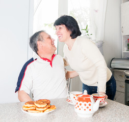 cheerful elderly couple  in   kitchen