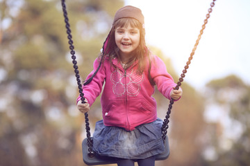 Adolescent girl swinging on a swing