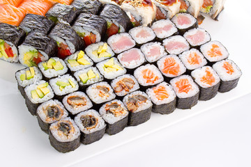 Sushi set with many fresh and tasty ingredients over white