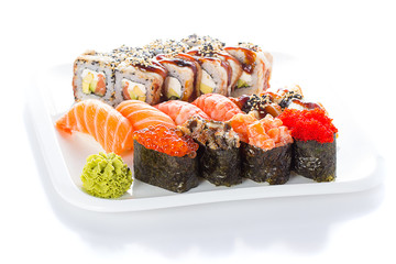 Set og sushi roll nigiri and gunkan on white plate over white