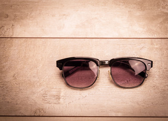 black sunglasses on wood floor