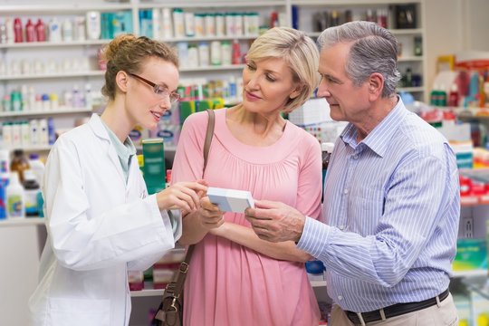 Pharmacist explaining the drug to costumers