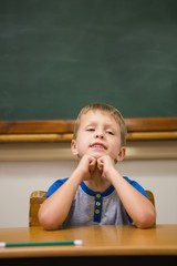 Smiling pupil sitting at his desk
