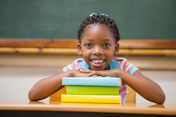 Smiling pupil sitting at her desk