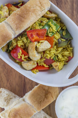 Bowl with curry flavored rice chicken and vegetables