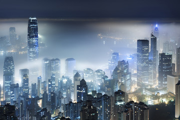 Fototapeta na wymiar Misty night view of Victoria harbor in Hong Kong city