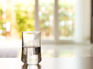 closeup Glass of water on table in the living room © Cozine