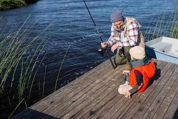 Happy man fishing with his son