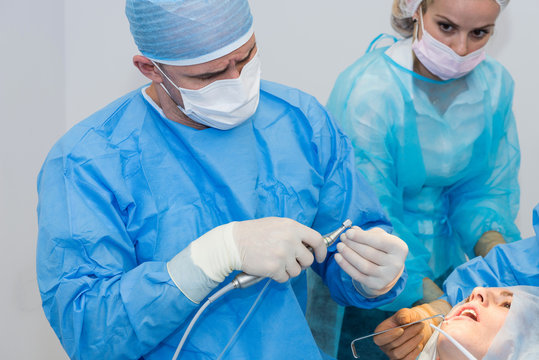 Dentists during surgery for implant placement