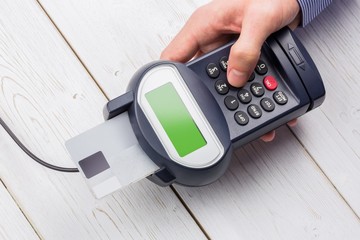 Man entering his pin on terminal