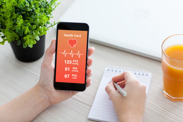 Women hands holding phone with app for health card monitoring