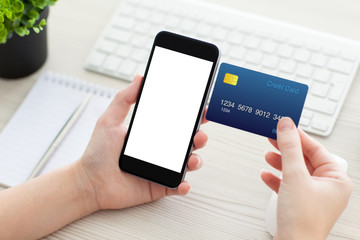 female hands holding phone with isolated screen and credit card