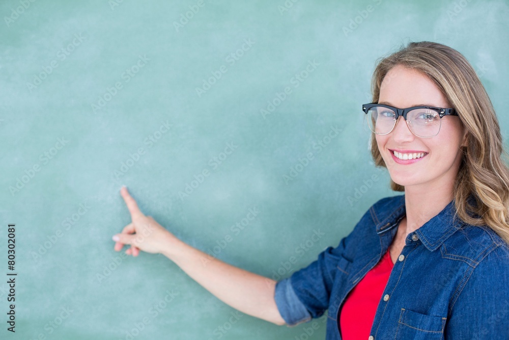 Poster smiling geeky teacher pointing the blackboard