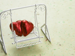 two heart shape chocolate on the swing